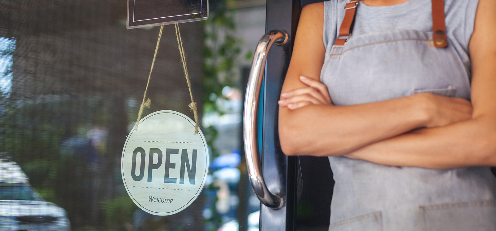 Business woman in front of open cafe.